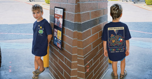Kid wearing the Always Printing Tee, front and back view